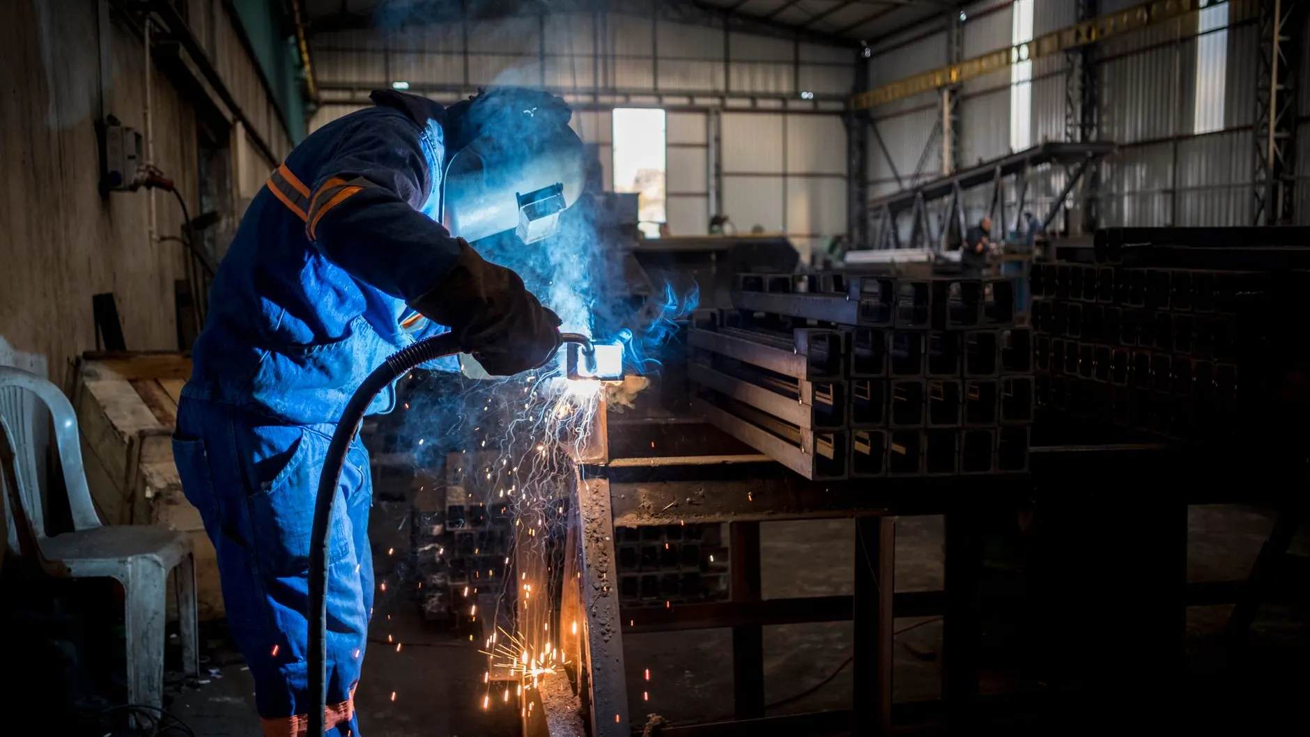 Farm equipment metal repair welding in progress on heavy steel implement