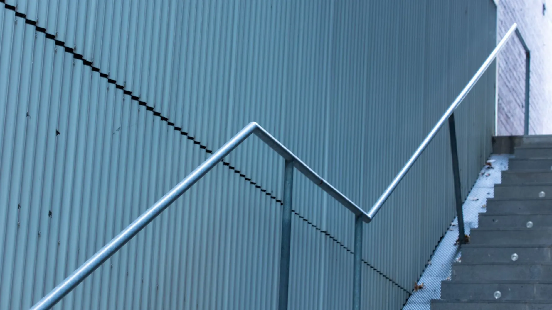 A custom metal stair railing installed along interior steps